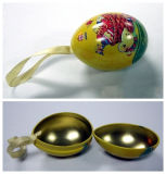 an Egg Shaped Metal Tin with Ribbon